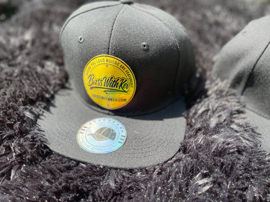 BASSWITHKEV BLACK FLAT BILL SNAPBACK HAT YELLOW BADGE